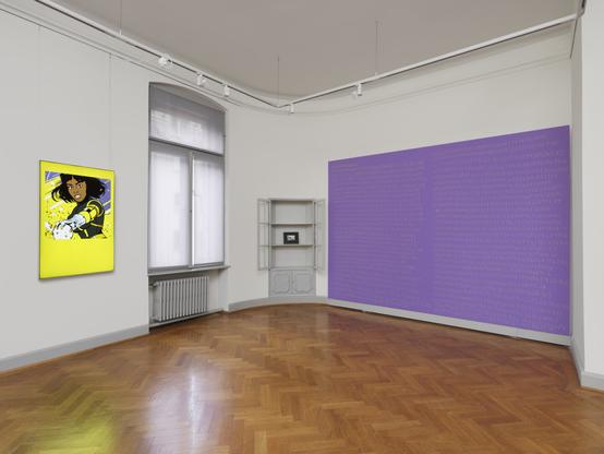 We see the corner of a room in which a grey display cabinet is built into the wall. Both hinged doors are wide open. There is only one picture frame in the cabinet. To the left of the cabinet hangs a light box with a picture of a comic book superheroine and to the right of the cabinet is a purple-coloured wooden panel that has been mounted on the wall. There are yellow numbers and letters on the wall. The floor of the room is covered with parquet and there is a window between the light box and the display cabinet.