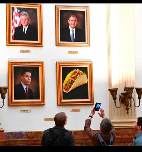 A wall with presidential portraits, there is a picture of a taco next to Obama.