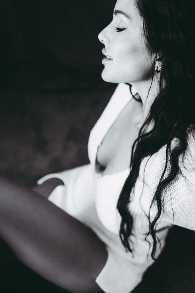 Mujer morena sentada en el suelo.