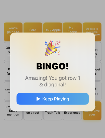 A screenshot of an iOS app that has a 5 x 5 bingo grid in the background with an alert on the screen showing bingo with the confetti emoji. There is a button that reads “keep playing” along with the text “amazing you got row 1 and diagonal”