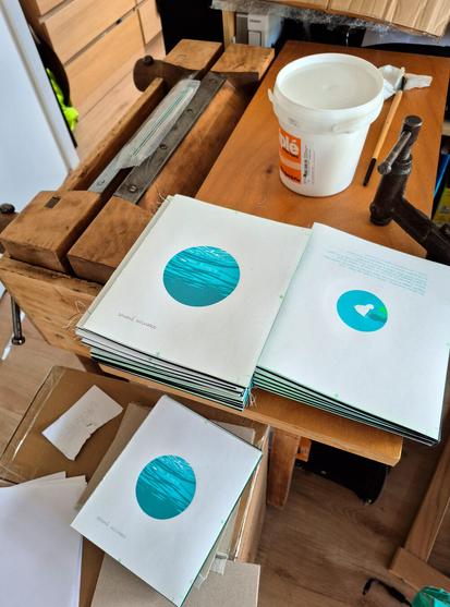 This is a photo of the bookbinding worktable, covered with several copies of the new book from PAPER - CUT editions, of which I’m a founding member. The book is screen printed and hand-bound. In this photo, the covers haven’t been added yet.