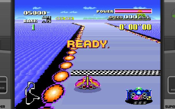 The image depicts a pixelated racing game scene. In the foreground, theres a stylized representation of an anti-gravity race machine with the number 2 prominently displayed on its side, indicating it is likely one of four vehicles available to play as in this particular mode of the game. The track appears to be set at night or under darkened conditions, given the muted colors and contrast. In the distance, there are two additional racing machines, both displaying the number 1, suggesting they are opponents controlled by AI or other players. At the top left corner of the screen, a yellow bar with white text reads POWER followed by an exclamation mark, likely indicating the players current power level, and theres also a smaller bar at the bottom right labeled READY, implying the status of whether the race is about to start or if its paused. The HUD Heads-Up Display in the upper left corner shows various gauges and indicators: two bars for health, one for speed, another for power, and a timer counting down from 60 seconds, which might be the current race duration limit. There are no visible texts or logos that provide specific game information or branding beyond what is standard within the SNES games of this era. The players viewpoint appears to be from an in-car perspective, offering a first-person gaming experience.
