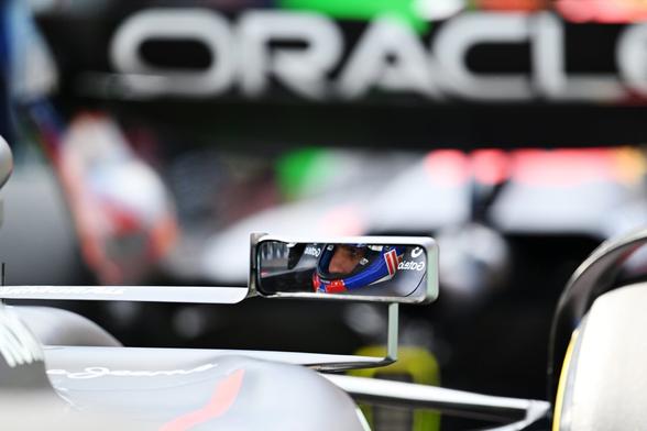 Max in the RB21, with his reflection showing in his wing mirror.