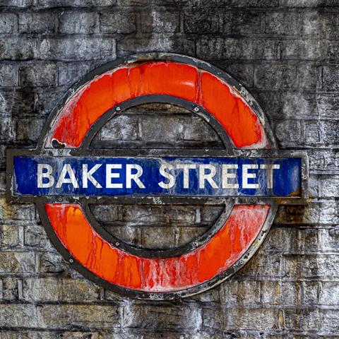 Underground logo on an old stone wall in the underground station Baker Street.