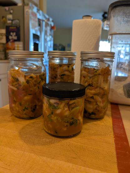 Kimchi in several different jars, ready to ferment