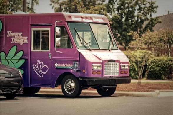 A delivery van for Harris Teeter, purple and pink
