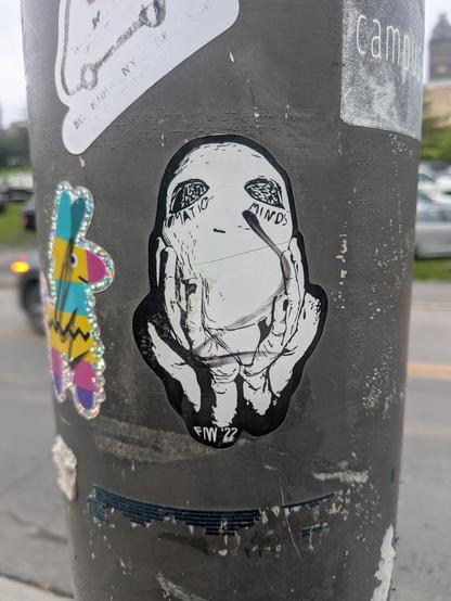 A sticker of a person wearing a white mask and the words "matio minds" on it