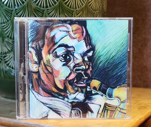 CD cover. A color drawing of a close-up of Albert Aylers face, while playing saxophone.