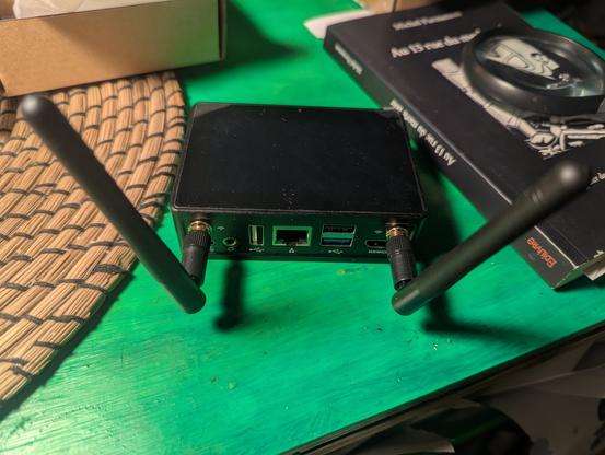 The back of the computer with an antenna at each end and ports for HDMI, USB 3, 2 and C, Ethernet, and audio.  USB C is for power.