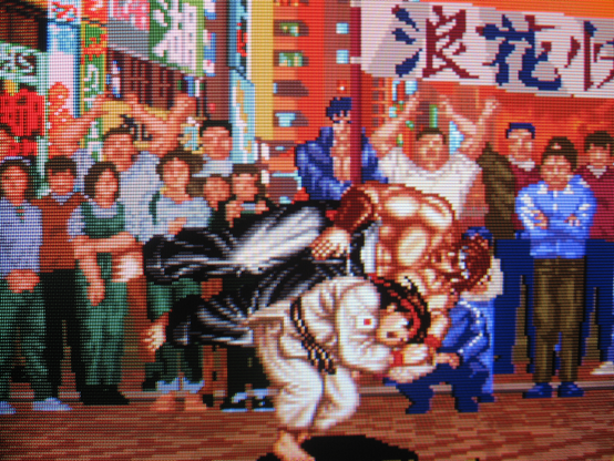 Ryoko shoulder-tosses Mizoguchi in the street and the gathered crowd cheers his pain.