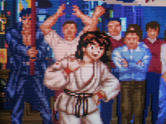 Having whipped Mizoguchi's ass, Ryoko gives a "hang-ten" hand gesture while winking cockily.