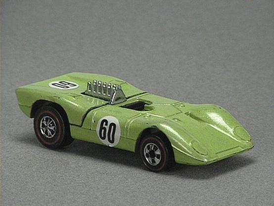 Released in 1973, Fluorescent Lime Green Ferrari 312P of 1973 Hot Wheels with Redline wheels. Notes: Rear engine cover lifts up. Packaging: 1973 Blister. Metal Body, Metal Base. Made in Hong Kong. Scarcity: 8/10
