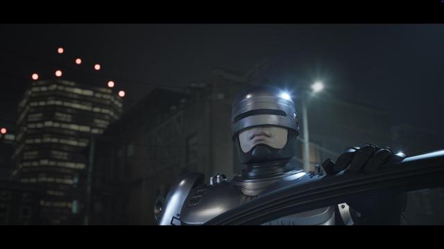 A futuristic robotic figure, resembling a law enforcement officer, stands prominently in a nighttime urban setting. The background features illuminated buildings and a dark sky, enhancing the sci-fi atmosphere.