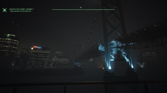 A nighttime view of a modern bridge illuminated by blue lights, with a city skyline in the background. The scene features mist or fog, creating a mysterious atmosphere. Text gaming overlay suggests goals related to a film set investigation.