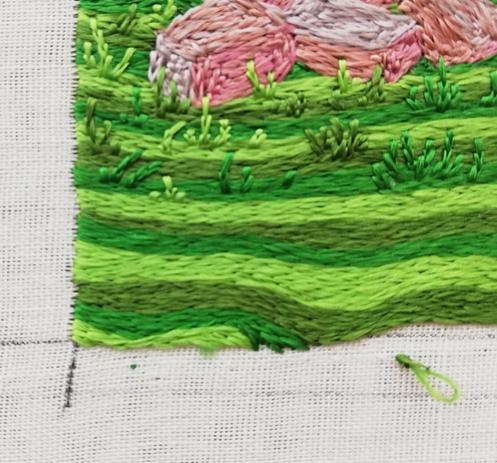 Close up of the lower left hand corner of a panel of opus anglicanum showing the first right angle filled in.