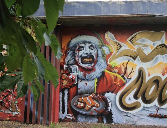 graffiti of Santa Claus eating the gingerbread man