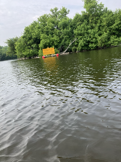 A floating sign off to the riverbank indication construction and no passage under the bridge
