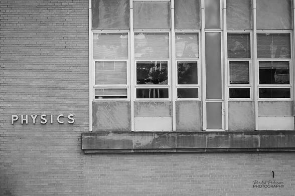 The exterior of a 1950s or 1960s era university building of brick and multiple windows.