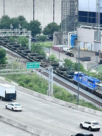 Dozens of military tanks being transported by train next to I-295 in Washington, DC