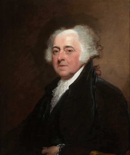Colour portrait of John Adams. He is wearing a dark suit, with a white shirt underneath. He is old, with grey hair on the sides. He is bald on top. He is staring directly at the viewer. His cheeks are rosy. His expression is serious.