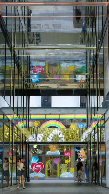 color photo in portrait format of part of an outdoor shopping complex corridor decorated with reflective glasses on all sides