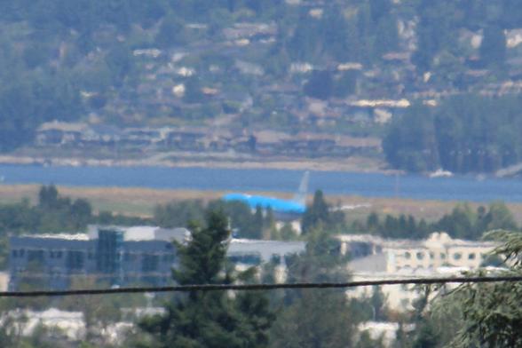 Boeing 777-200ER KLM Flight 615 from Amsterdam AMS arriving at Portland PDX. This is around the point of touchdown on Portland Runway 28R. The zoomed shot includes buildings in the vicinity or PDX Airport. Behind the aircraft in this perspective is the Columbia River and on the other side a hillside with trees and homes in Vancouver, Washington.
photo by Ian Kluft
June 7, 2025
Portland, Oregon, USA🇺🇸