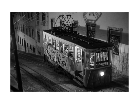 one of lisbons eletrico trams at final destination point uphill, shot in black and white