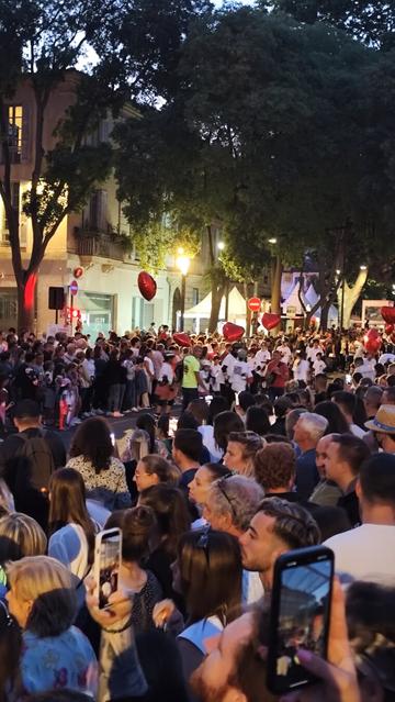 A lot of people in féria, Nîmes 2025. Night street fiesta.