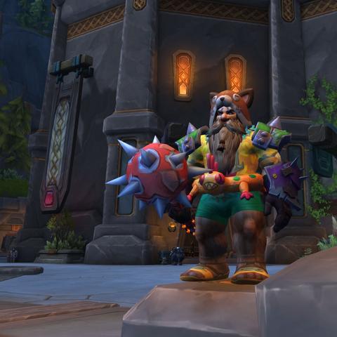My player character 'Grokknar' in World of Warcraft. He's pictured wearing bright yellow and green swimwear (complete with an orange Murloc shaped rubber ring around his waist), a Fox hat (with ears) as well as green and spiky pauldrons, and purple and spiky gloves. He's carrying a comically large red and spiky mace. All the colours of the rainbow essentially.