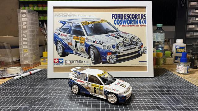 Finished model of a Ford Escort RS Cosworth by Tamiya in 1:24 on top of a workbench.