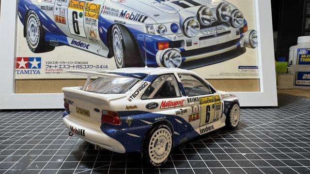 Finished model of a Ford Escort RS Cosworth by Tamiya in 1:24 on top of a workbench.