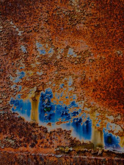 Corrosion photo with reddish color and blue accents