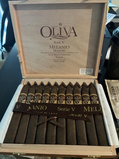 Photo of an open box of 10 cigars. The label is clearly visible. MELANIO
MADURO Gran Reserva Limitada Torpedo
