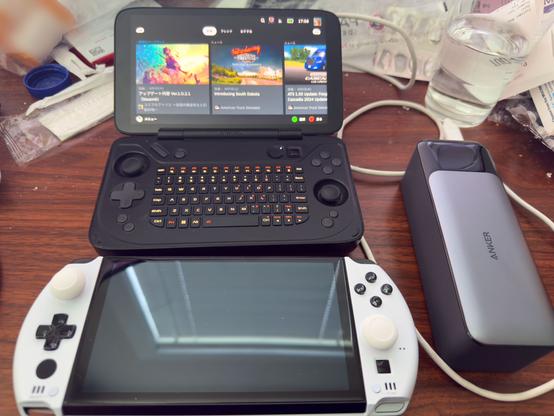 Comparison of an Ayaneo Flip KB and a GPD Win 4 with a portable battery bank.