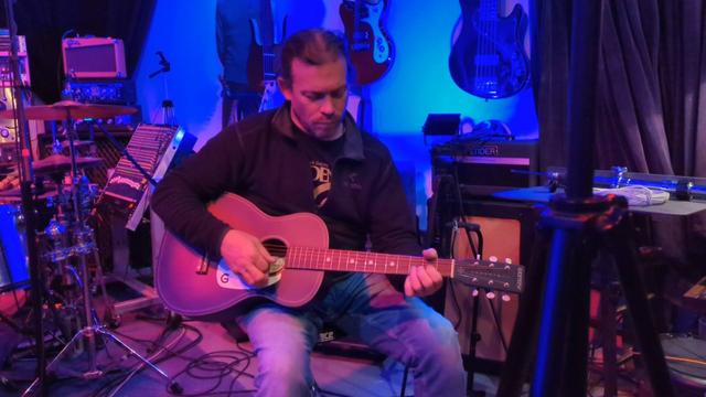 Person playing acoustic guitar