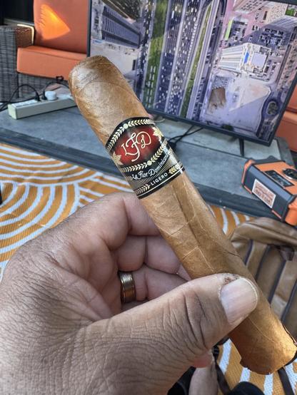 Picture of me holding an unlit La Flor Dominicana LFD Ligero 707.