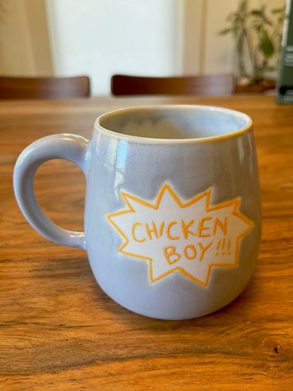 The back of the mug with the words “chicken boy” written on it