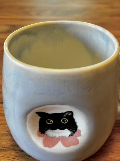 A glaze detail of the mug, showcasing the light blue and white drips on the inside rim