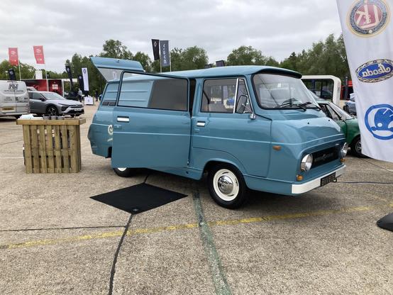 Mid-blue Skoda 1203 van being used as a coffee truck with large front-hinged side door open, front quarter view