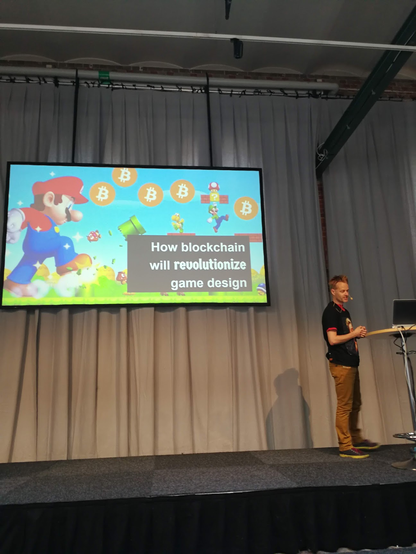 A slide from nordic game talk that says , "How blockchain will revolutionize game design"