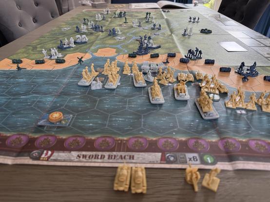 Memoir 44 Sword Beach map. View from the sea end of the map. British troops foreground. German background.