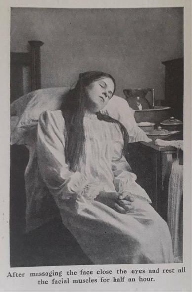 Old black and white photo of a long dark haired white woman, lying eyes closed in a seat her head resting on a cushion. She's wearing an old fashioned long white nightdress.

The caption reads: After massaging the face close the eyes and rest all the facial muscles for half an hour.
