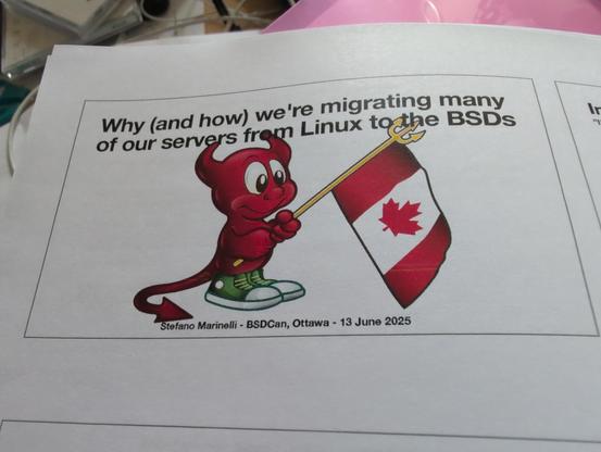 A printed presentation slide featuring the BSD Daemon mascot holding a Canadian flag with a pitchfork. The title reads, "Why (and how) we're migrating many of our servers from Linux to the BSDs." The presenter is Stefano Marinelli, and the event is BSDCan in Ottawa on 13 June 2025.
