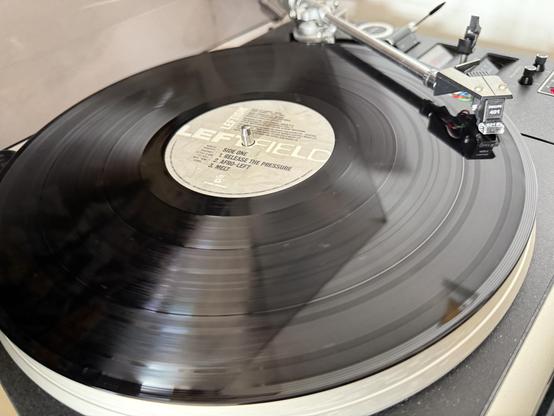Side one of the vinyl record Leftism by Leftfield playing on a 40-year-old turntable