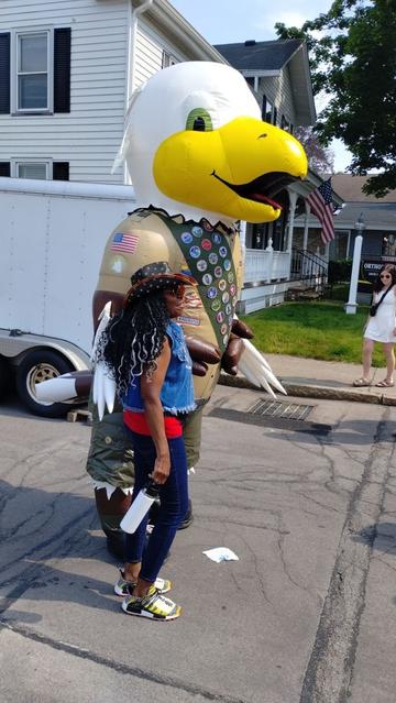 Baldy the Eagle Scout standing next to a woman.