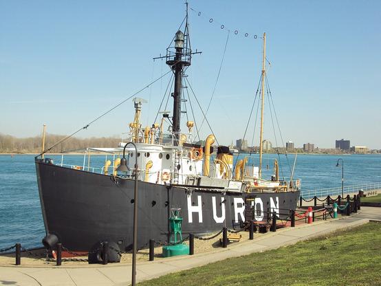 HURON (lightship) - Port Huron, Michigan. A black hulled ship with a tall light mast.