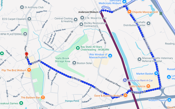 Google maps directions showing a purple line of the Lowell Commuter Train arriving from Boston. A blue line of walking starts where the purple line ends, jutting out to the east, before diving for a mile south, veering west again and then finally north-west in a ridiculous circumnavigation to arrive at the destination.
