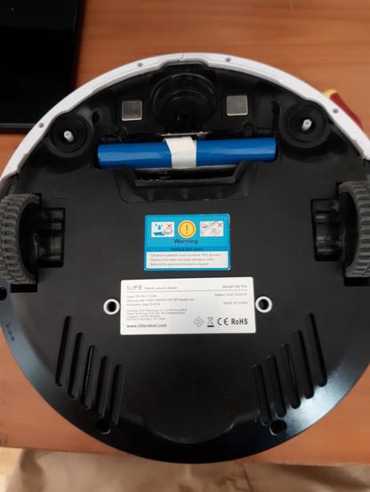 Arrière de l'aspirateur avec trappe ouverte et batterie apparente