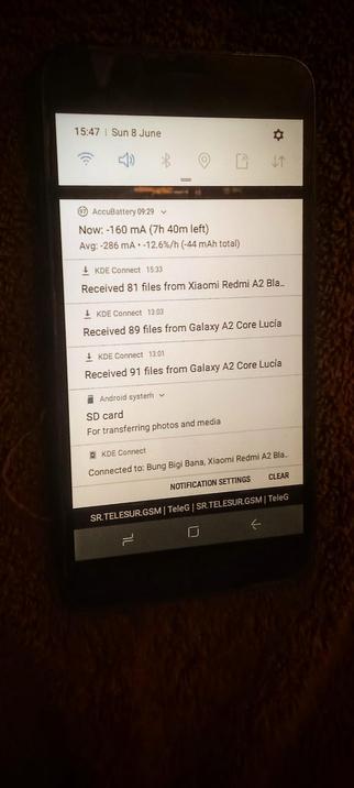 The photograph shows a smartphone screen displaying a notification panel. The time is 15:47, and the date is Sunday, 8 June. The battery level is at 97%, with a current discharge rate of -160 mA and an average rate of -286 mA, indicating a total discharge of -44 mAh. The screen shows notifications from KDE Connect, indicating file transfers from devices such as a Xiaomi Redmi A2 and a Galaxy A2 Core Lucia. The SD card is mentioned for transferring photos and media. The device is connected to "Bung Bigi Bana" via KDE Connect. The bottom of the screen shows the network provider "SR.TELESUR.GSM" and the Telegram app icon. The background of the phone is dark, and the screen is illuminated, making the text and icons clearly visible.

 Ovis2-8B

🌱 Energy used: 0.212 Wh