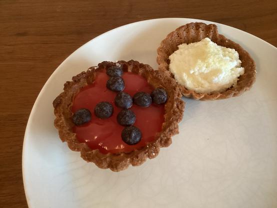 Two small tartlets on white plate.
